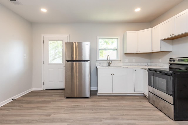 2539 Kenwood Rd, Bartlett, TN 38134 - kitchen featuring stainless steel appliances, light countertops, white cabinets, recessed lighting, and light wood finished floors