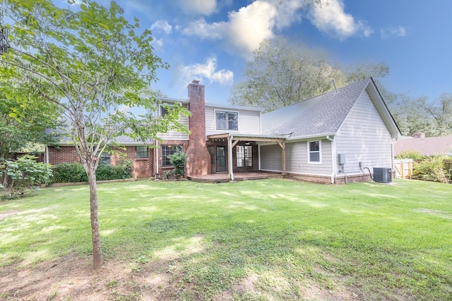 2539 Kenwood Rd, Bartlett, TN 38134 - rear view of house with a chimney, a yard, and a patio