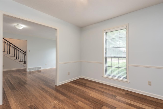 2539 Kenwood Rd, Bartlett, TN 38134 - empty room with wood finished floors and stairs