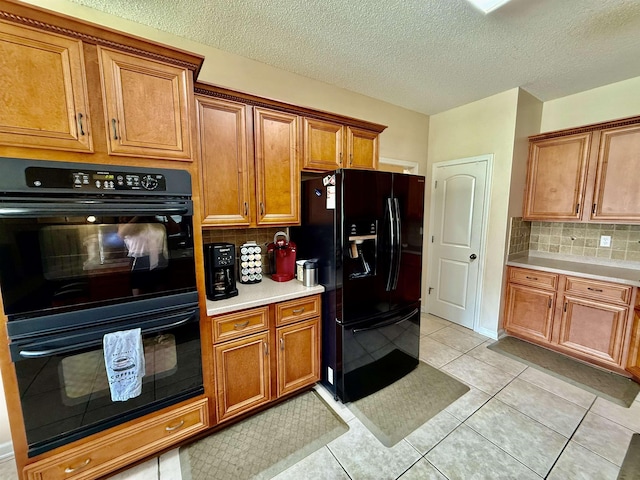 6632 W Thriveaway Cv, Bartlett, TN 38135 - kitchen with black appliances, brown cabinetry, light countertops, decorative backsplash, and light tile patterned floors