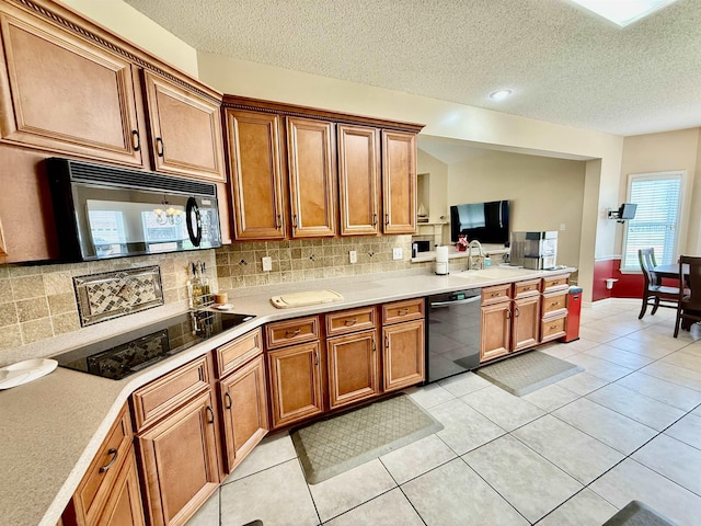 6632 W Thriveaway Cv, Bartlett, TN 38135 - kitchen with black appliances, brown cabinets, backsplash, light countertops, and a textured ceiling
