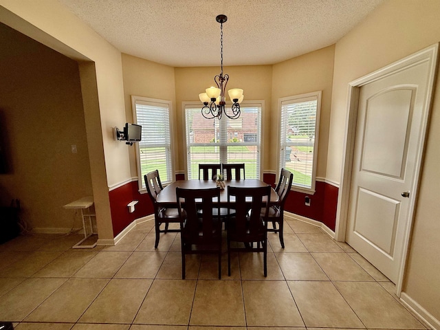 6632 W Thriveaway Cv, Bartlett, TN 38135 - dining area featuring a chandelier, a textured ceiling, and light tile patterned floors