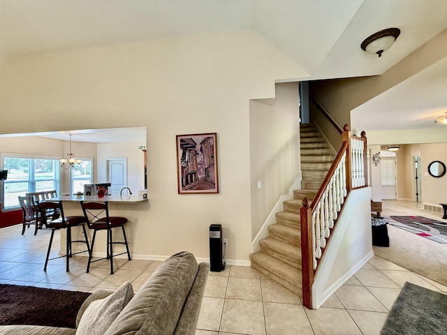 6632 W Thriveaway Cv, Bartlett, TN 38135 - staircase with a chandelier, tile patterned floors, and lofted ceiling
