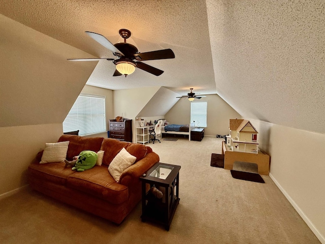 6632 W Thriveaway Cv, Bartlett, TN 38135 - living room featuring carpet flooring, lofted ceiling, plenty of natural light, ceiling fan, and a textured ceiling