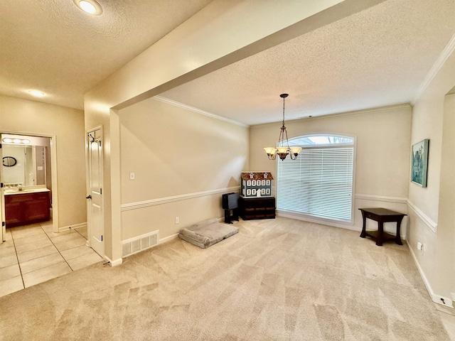 6632 W Thriveaway Cv, Bartlett, TN 38135 - carpeted empty room featuring a textured ceiling, crown molding, a chandelier, and tile patterned floors