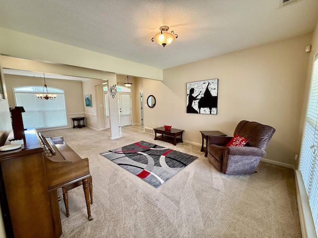 6632 W Thriveaway Cv, Bartlett, TN 38135 - living room with carpet floors, a chandelier, and a textured ceiling