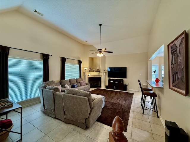 6632 W Thriveaway Cv, Bartlett, TN 38135 - living room with high vaulted ceiling, light tile patterned floors, ceiling fan, and a fireplace