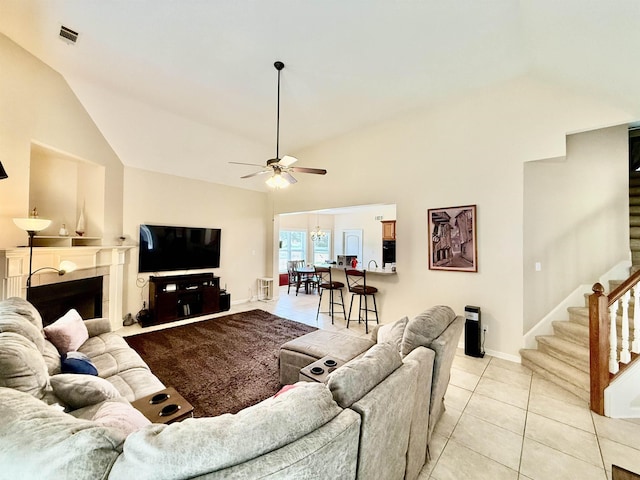 6632 W Thriveaway Cv, Bartlett, TN 38135 - living area with vaulted ceiling, stairs, ceiling fan, light tile patterned flooring, and a fireplace