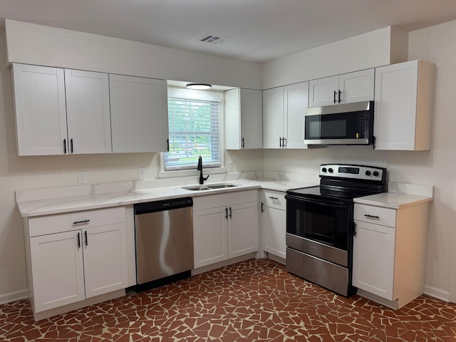 3652 Acacia St, Memphis, TN 38116 - kitchen featuring stainless steel appliances and white cabinetry