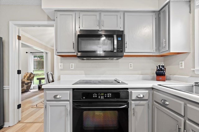 3077 Stonecrest Cir E, Lakeland, TN 38002 - kitchen with black appliances, gray cabinetry, and light countertops