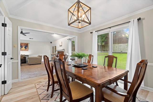 3077 Stonecrest Cir E, Lakeland, TN 38002 - dining space with light wood finished floors, ornamental molding, a chandelier, and a ceiling fan