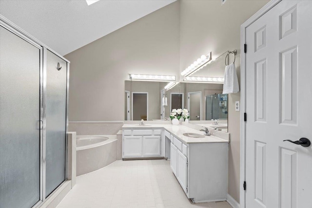 3077 Stonecrest Cir E, Lakeland, TN 38002 - full bathroom featuring a shower stall, double vanity, a bath, and vaulted ceiling
