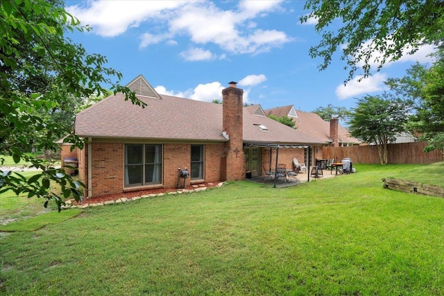 3077 Stonecrest Cir E, Lakeland, TN 38002 - rear view of property featuring a patio, brick siding, a chimney, and roof with shingles