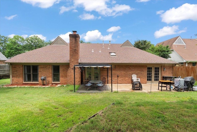 3077 Stonecrest Cir E, Lakeland, TN 38002 - back of property featuring french doors, a patio area, and brick siding
