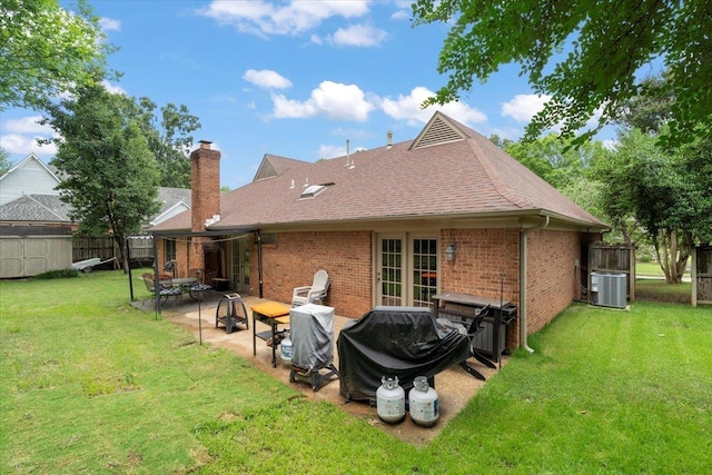 3077 Stonecrest Cir E, Lakeland, TN 38002 - back of property with brick siding, a chimney, a shingled roof, and a patio
