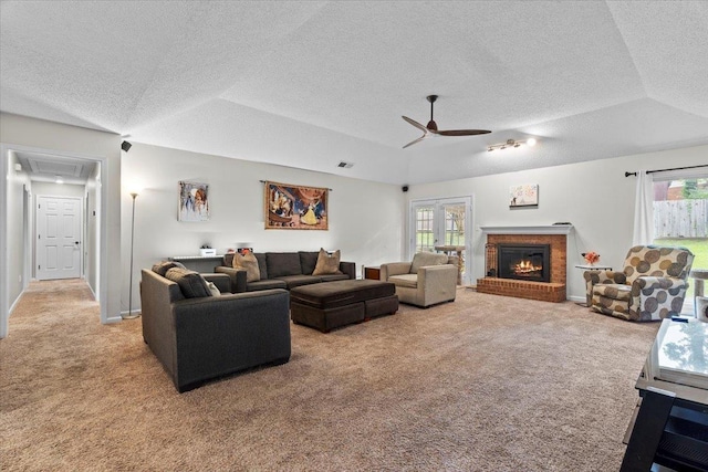 3077 Stonecrest Cir E, Lakeland, TN 38002 - living area with light carpet, a brick fireplace, a textured ceiling, vaulted ceiling, and ceiling fan