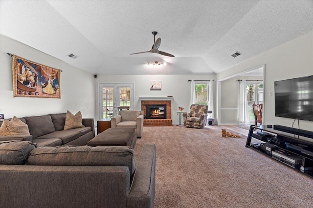 3077 Stonecrest Cir E, Lakeland, TN 38002 - living area featuring vaulted ceiling, carpet floors, a fireplace, a ceiling fan, and a textured ceiling