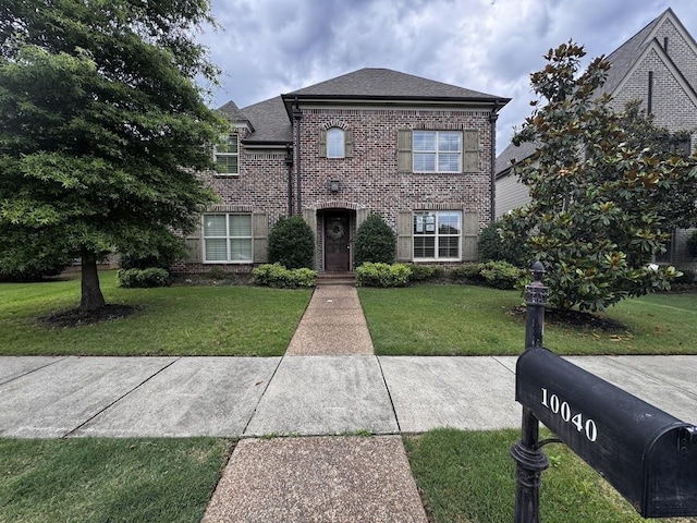 10040 Dropseed Cir, Lakeland, TN 38002 - traditional-style house featuring brick siding, a front yard, and a shingled roof