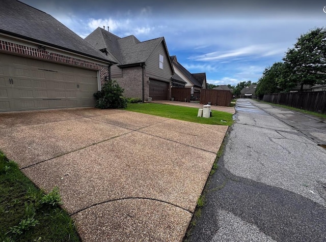 10040 Dropseed Cir, Lakeland, TN 38002 - view of home's exterior featuring brick siding and driveway