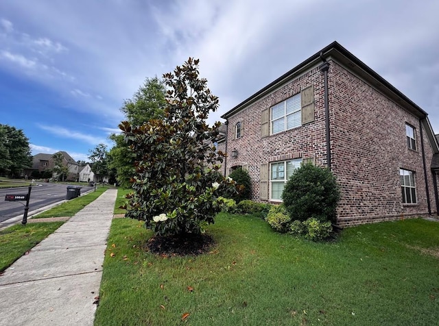 10040 Dropseed Cir, Lakeland, TN 38002 - view of side of property featuring brick siding and a lawn