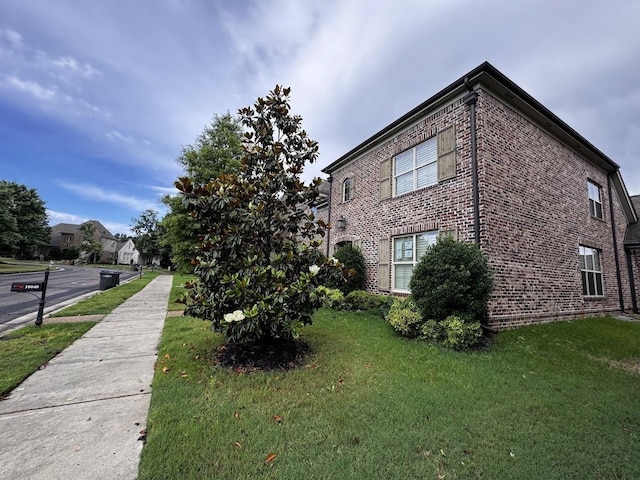 10040 Dropseed Cir, Lakeland, TN 38002 - view of side of property with brick siding and a yard