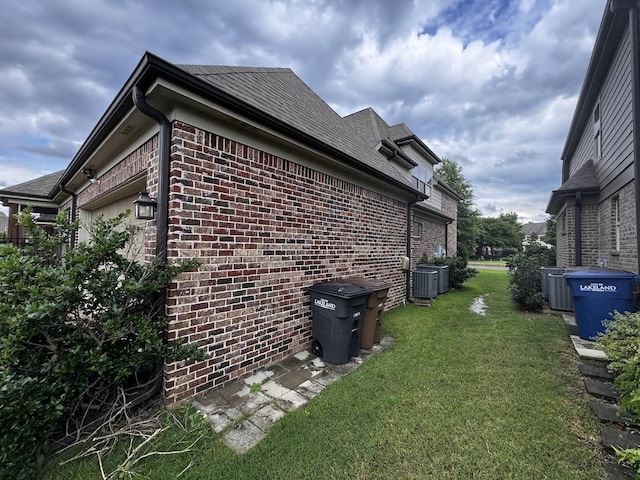 10040 Dropseed Cir, Lakeland, TN 38002 - view of side of home featuring brick siding and a yard