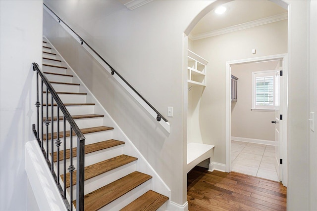 10040 Dropseed Cir, Lakeland, TN 38002 - stairway featuring crown molding, wood finished floors, and arched walkways