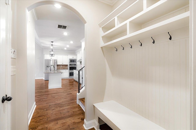 10040 Dropseed Cir, Lakeland, TN 38002 - mudroom with arched walkways, ornamental molding, wood finished floors, and recessed lighting