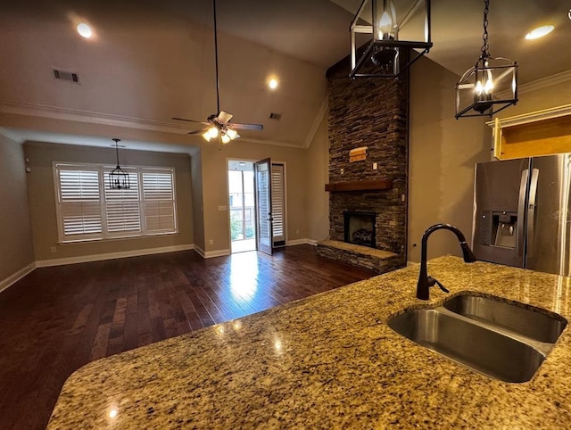 10040 Dropseed Cir, Lakeland, TN 38002 - kitchen with stainless steel fridge with ice dispenser, ornamental molding, open floor plan, dark wood finished floors, and a fireplace