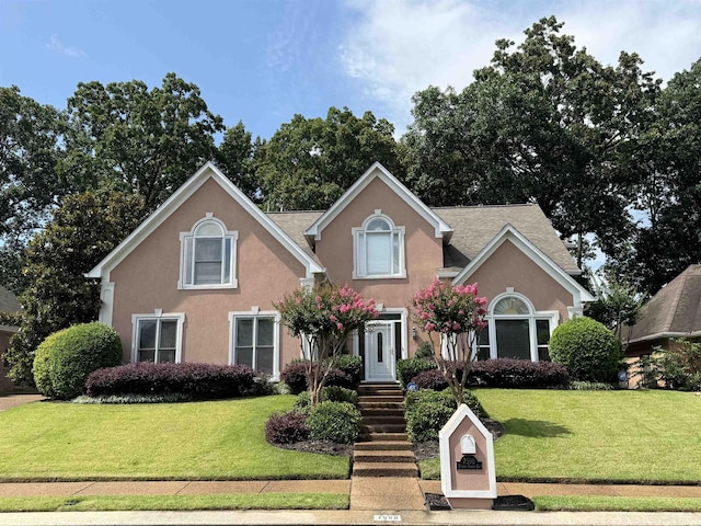 7598 Fairway Forest Dr E, Memphis, TN 38016 - traditional home with a front lawn and stucco siding