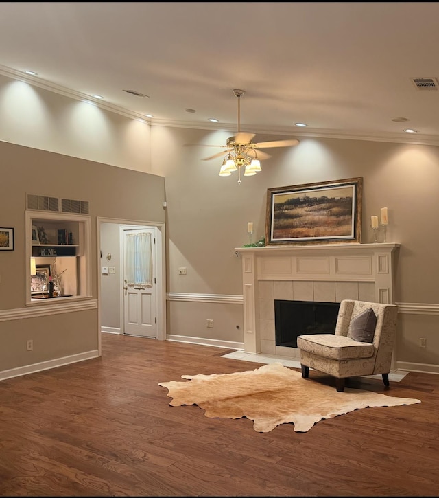 7598 Fairway Forest Dr E, Memphis, TN 38016 - living area featuring crown molding, wood finished floors, a ceiling fan, a fireplace, and recessed lighting