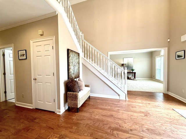 7598 Fairway Forest Dr E, Memphis, TN 38016 - entryway with wood finished floors, crown molding, stairway, and a high ceiling