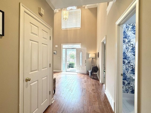 7598 Fairway Forest Dr E, Memphis, TN 38016 - entrance foyer with crown molding, dark wood-style floors, and a towering ceiling