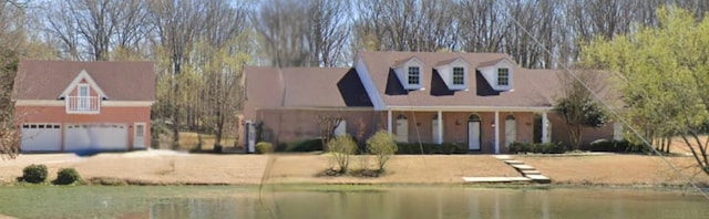 4740 Dustin Place Dr, Southaven, MS 38671 - cape cod-style house with a water view, a garage, and driveway
