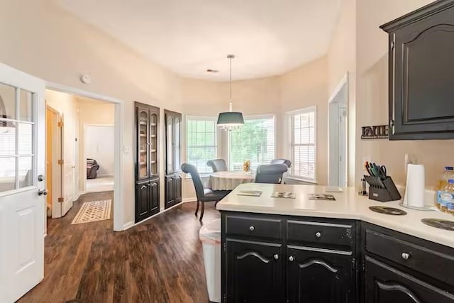4740 Dustin Place Dr, Southaven, MS 38671 - kitchen featuring a peninsula, light countertops, dark wood-style flooring, hanging light fixtures, and dark cabinetry