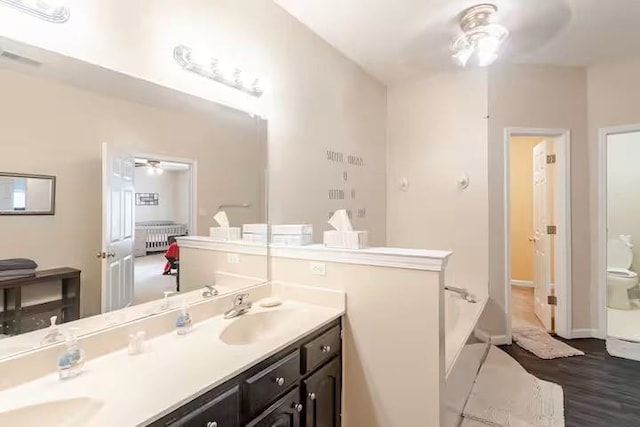 4740 Dustin Place Dr, Southaven, MS 38671 - full bathroom with ceiling fan, double vanity, radiator heating unit, a bath, and wood finished floors