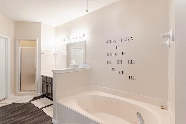 4740 Dustin Place Dr, Southaven, MS 38671 - full bath featuring a jetted tub, vanity, a shower stall, and wood finished floors