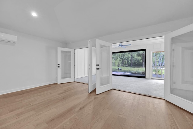 9700 N Helene Cv, Millington, TN 38053 - spare room featuring a wall mounted air conditioner, light wood-style floors, ceiling fan, french doors, and recessed lighting