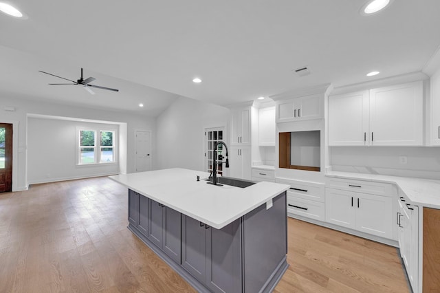 9700 N Helene Cv, Millington, TN 38053 - kitchen featuring gray cabinets, a ceiling fan, a center island with sink, light wood-type flooring, and white cabinets
