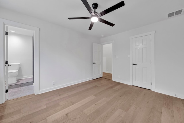 9700 N Helene Cv, Millington, TN 38053 - unfurnished bedroom featuring light wood-style floors, ensuite bath, and a ceiling fan