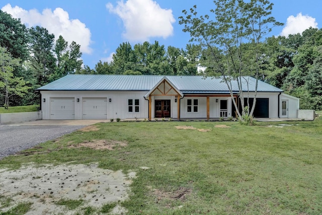 9700 N Helene Cv, Millington, TN 38053 - modern farmhouse style home with gravel driveway, a front lawn, board and batten siding, and a garage