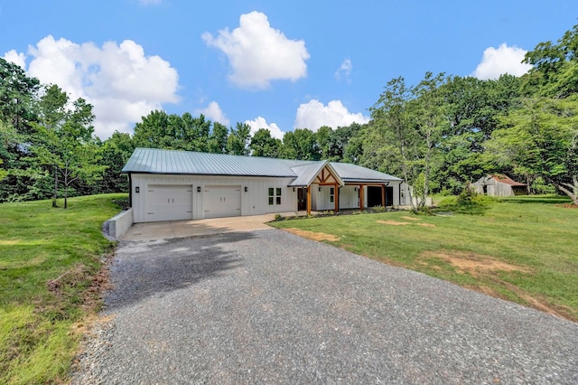 9700 N Helene Cv, Millington, TN 38053 - modern farmhouse style home with gravel driveway, a garage, board and batten siding, and a front yard