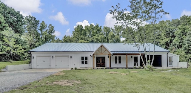 9700 N Helene Cv, Millington, TN 38053 - modern farmhouse with an attached garage, asphalt driveway, a front yard, board and batten siding, and covered porch