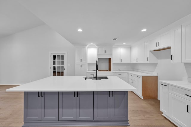 9700 N Helene Cv, Millington, TN 38053 - kitchen with an island with sink, gray cabinets, light wood-style flooring, recessed lighting, and white cabinetry