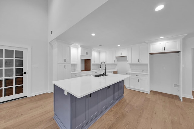 9700 N Helene Cv, Millington, TN 38053 - kitchen with gray cabinetry, white cabinetry, an island with sink, light wood-style flooring, and recessed lighting