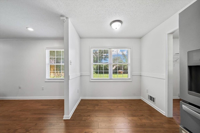 6864 Aspenhill Dr, Bartlett, TN 38135 - unfurnished dining area with wood finished floors and a textured ceiling