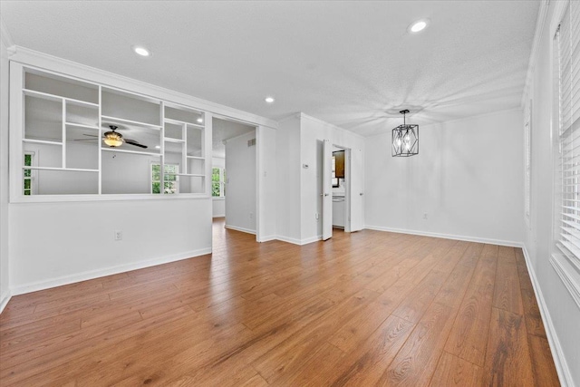 6864 Aspenhill Dr, Bartlett, TN 38135 - unfurnished room featuring a chandelier, ceiling fan, recessed lighting, wood finished floors, and ornamental molding