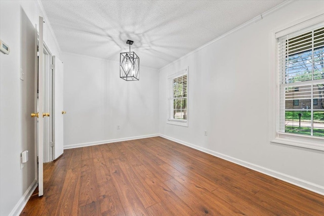 6864 Aspenhill Dr, Bartlett, TN 38135 - unfurnished room with dark wood finished floors, crown molding, and a textured ceiling
