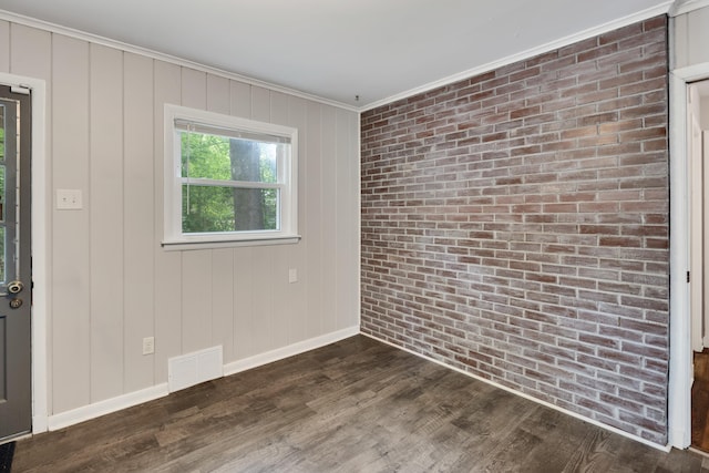 3218 Joffre Ave, Memphis, TN 38111 - spare room featuring crown molding, dark wood-style floors, and brick wall