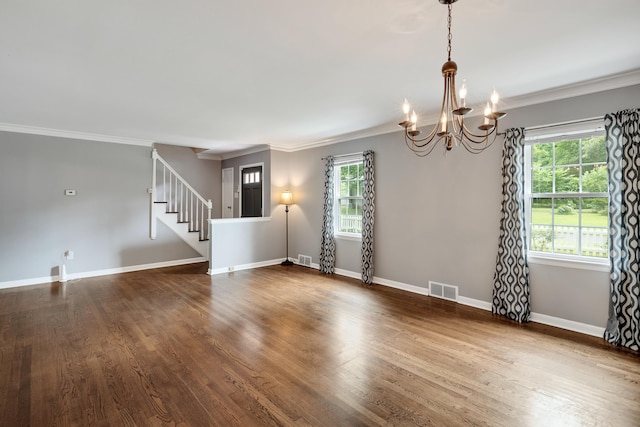 3218 Joffre Ave, Memphis, TN 38111 - spare room with ornamental molding, a chandelier, plenty of natural light, stairs, and dark wood-style floors